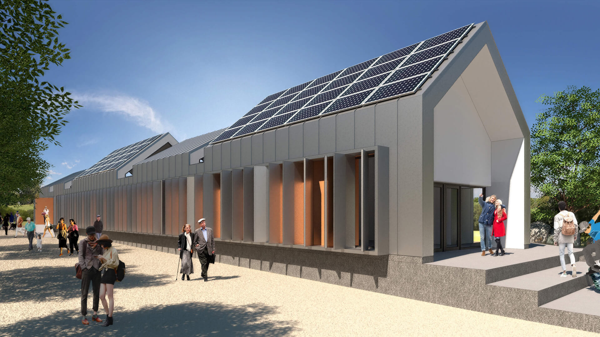 Edificio público rehabilitado energéticamente, mostrando la celosía de zinc de su fachada y los paneles solares en el techo.