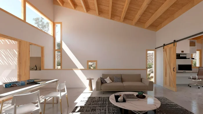 Interior del salón de una casa estrecha y alargada en Madrid, con techos de madera vista y entrada de luz natural. Diseño de HGSE Arquitectos.